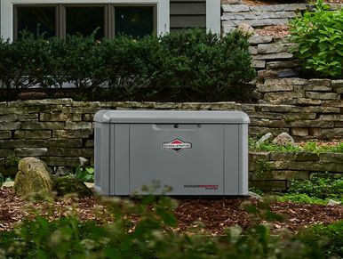 A Briggs and Stratton PowerProtect™ DX 20W Standby Generator in front of a house.