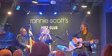 Live jazz performance at Ronnie Scott's Jazz Club with musicians and a singer.