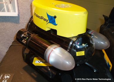 Yellow and black underwater robot labeled VideoRay with NTSC Scout camera.