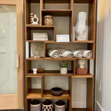 Spa Shelving with spa items displayed on all of the shelves in an organized way.