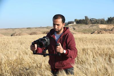 Hosny Salah filming in Gaza in a field