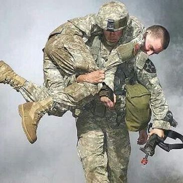 Army Soldier carrying  another soldier to safety