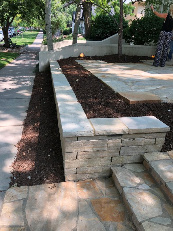 Flagstone steps and patio with stone retaining wall