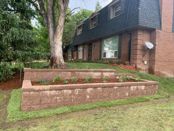 Planting area made from a retaining wall
