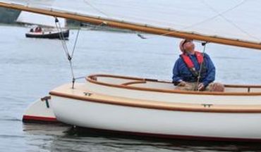 a 16' cat boat racing on Pleasant Bay on Cape Cod