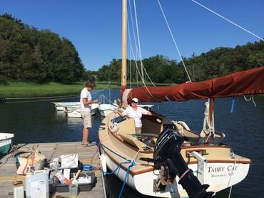 A 17' cat boat at the NSA dock on Frost Fish Cove, Orleans MA on Cape Cod