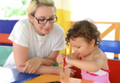Woman and toddler painting together.