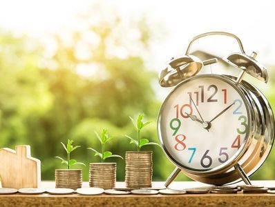 "Clock and money showing an investment growing in value"