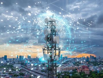 Telecommunication tower with digital network connections over a cityscape.