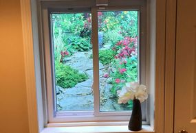 Beautify your unattractive window wells with weather resistant window well scenes.