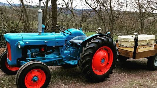 A Blue tractor hearse