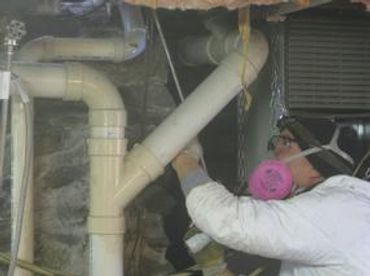 Sealing around plumbing in the basement.