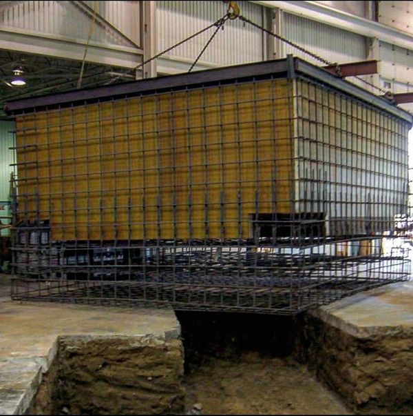 Prefabricated Form System for a concrete foundation being positioned by crane.
