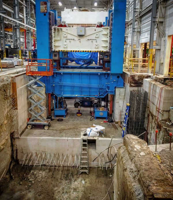 Construction of a press pit for heavy machinery in manufacturing facility.