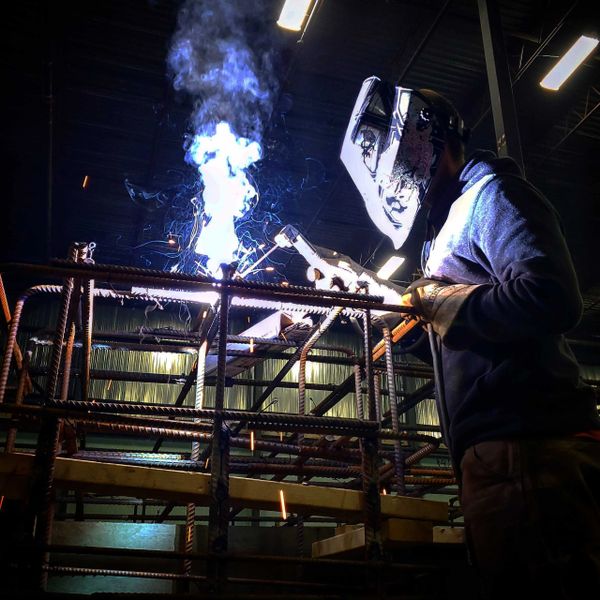 A welder is welding together rebars.