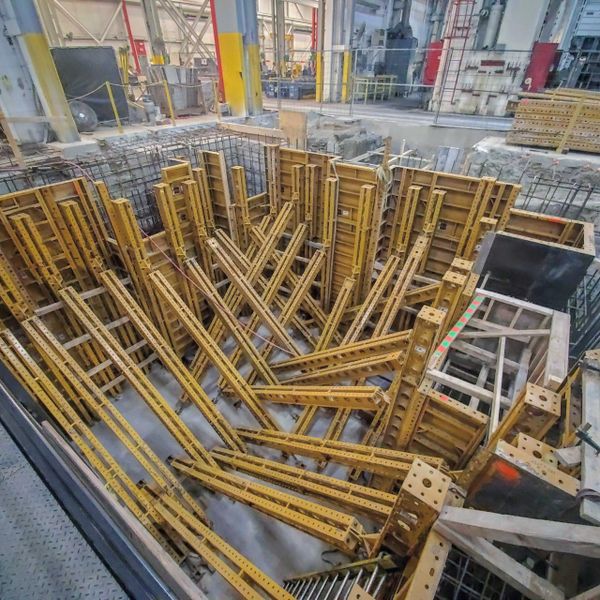 Construction of a concrete machine foundation in a manufacturing facility.