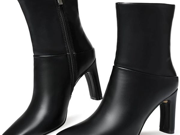 Pair of sleek black leather ankle boots with block heels and side zippers.