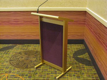 Empty podium with microphone in a corner of a room.