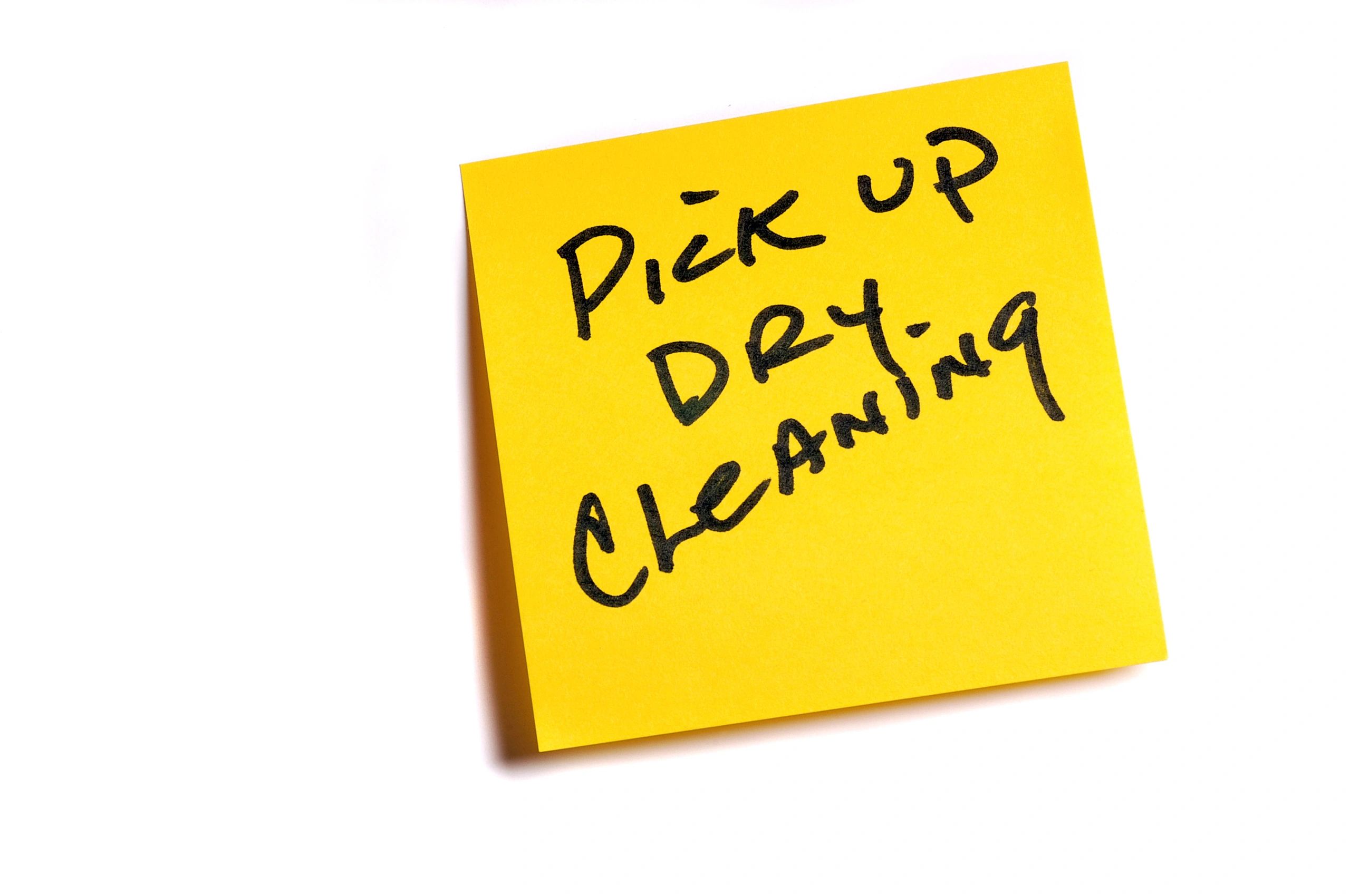 Sticky note that says pick up dry cleaning
