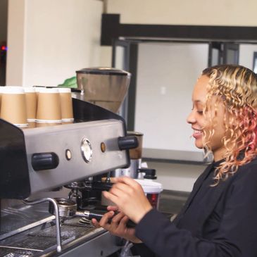 Person smiling making coffee.
