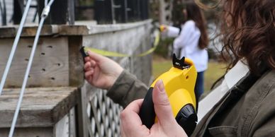 Site visit - measuring the deck with a  yellow measuring tape