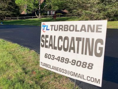 Sign advertising Turbolane sealcoating services with contact details.