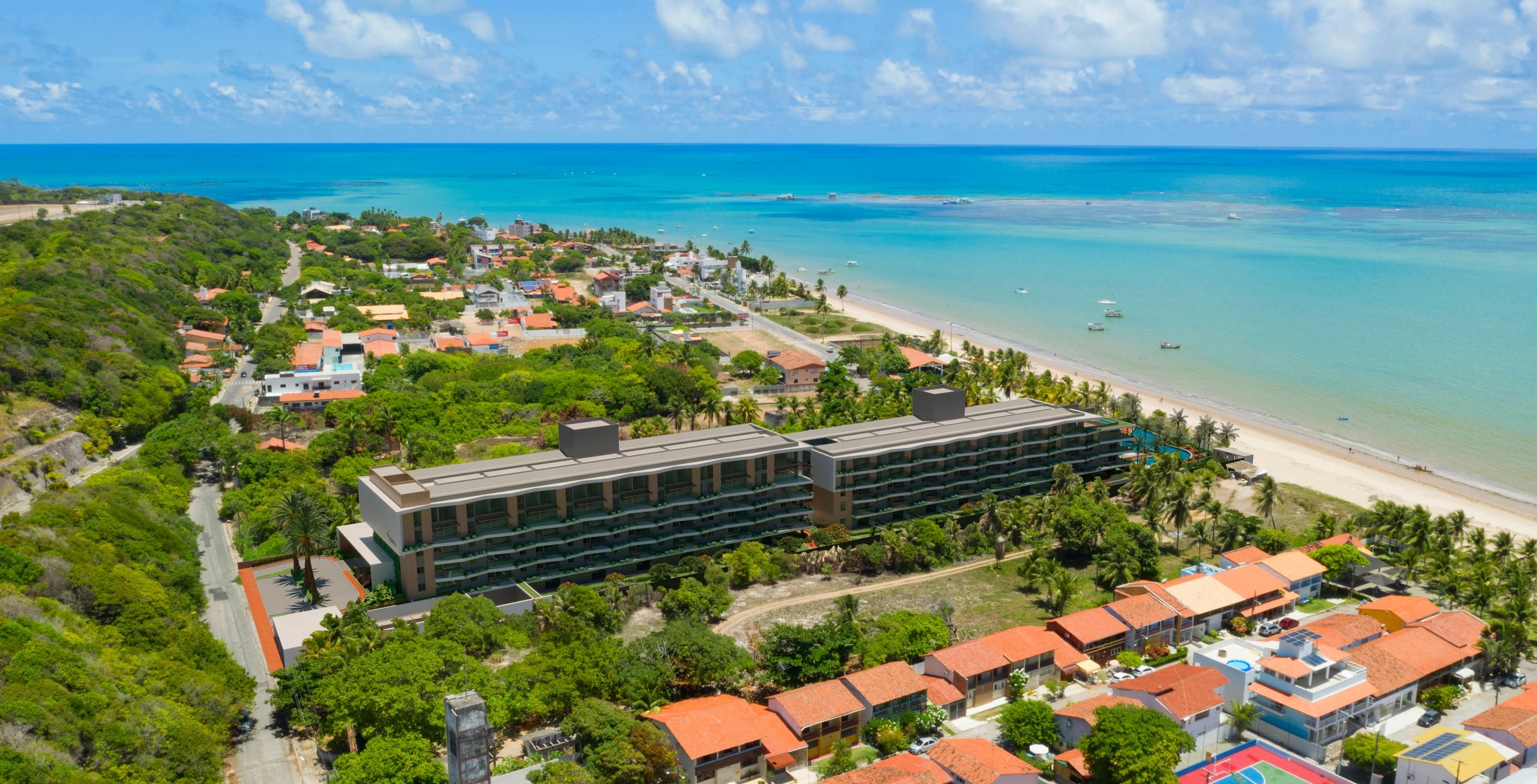 A coastal town with a large beachside resort and turquoise ocean waters.