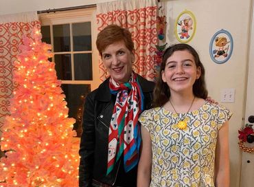 girl wearing cute cranky face "bad sun" ceramic clay necklace by Los Angeles artist Camille Stancin