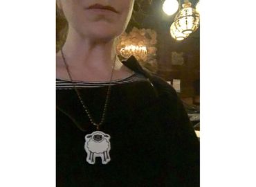 woman wearing cute cranky fluffy sheep ceramic clay necklace by Los Angeles artist Camille Stancin