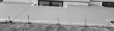 Concrete walkway and window wells with broom finish