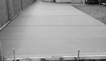 Large concrete backyard patio with broom finish