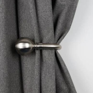 Handmade Metal holdback holding curtain.