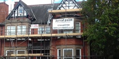 house painting with scaffold 
