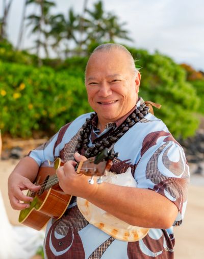 Reverend Charles Hahale playing at ukulele