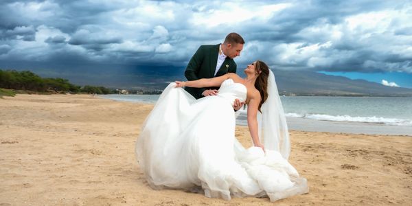 Wedding couple doing dip photo at Sugar beach Maui.