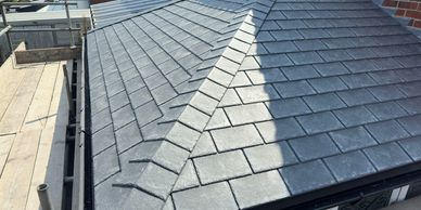 Newly installed slate roof tiles with clean lines and sharp edges.