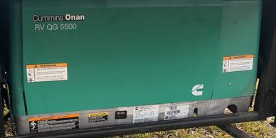 Cummins Onan RV QG 5500 generator installed outdoors.