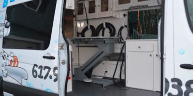 Interior of a white service van with equipment and cabinets.