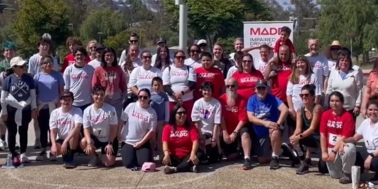 Group photo of people at a MADD event promoting impaired driving awareness.