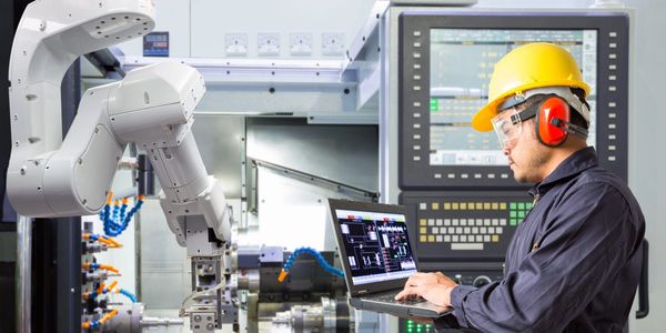 Cobots in manufacturing facilities driving Industry 4.0, working alongside humans.