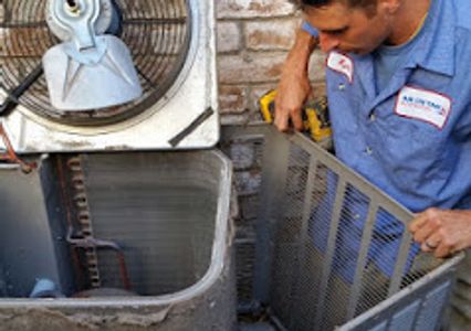 HVAC technician performing ac repair and maintenance on an air conditioner in Conroe, Texas.