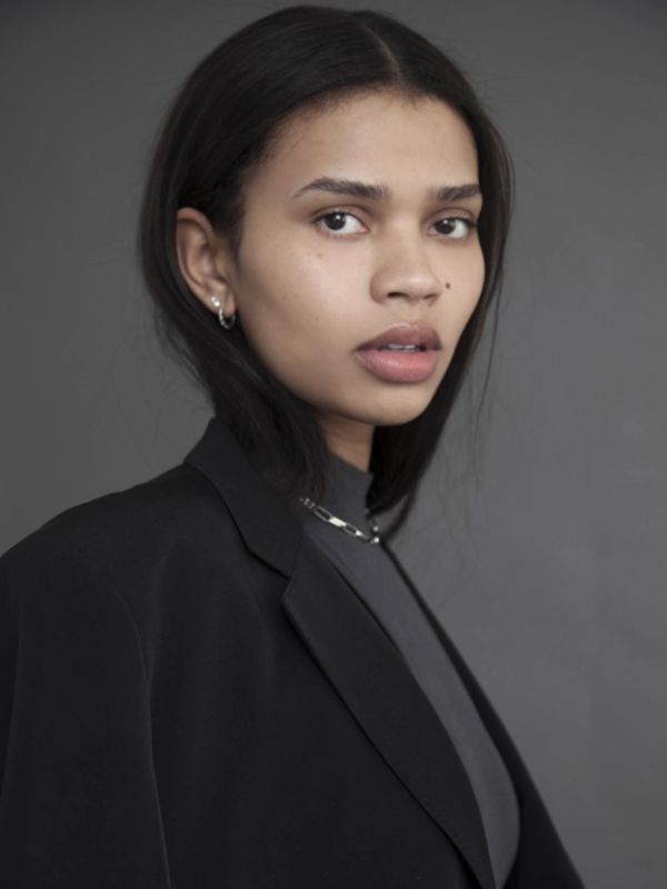 Portrait of a young woman in a black blazer.
