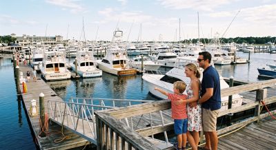 Family enjoying a view of boats at the marina.