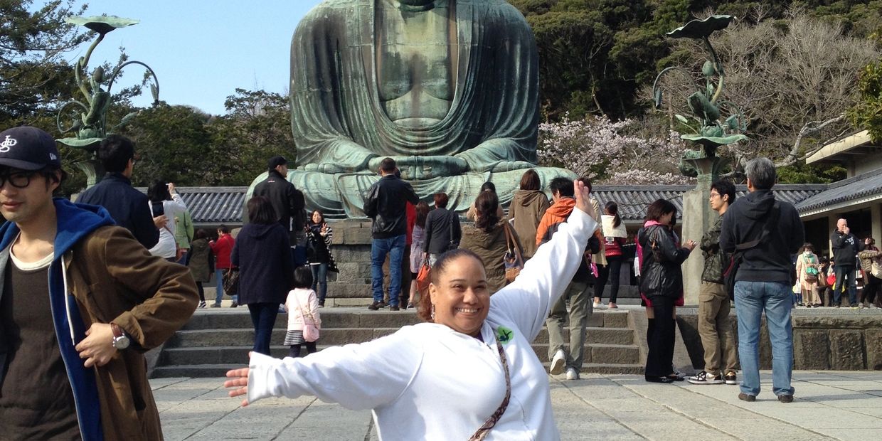 Melanie Serrano is visiting the Great Buddha of Kamakura in Japan, reflecting her love of connection, culture, and meaningful life journeys.