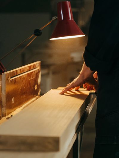 A man preparing to cut a piece of wood