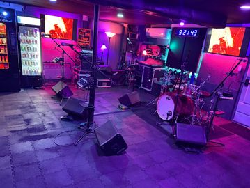 A vibrant music studio with instruments and colorful lighting.
