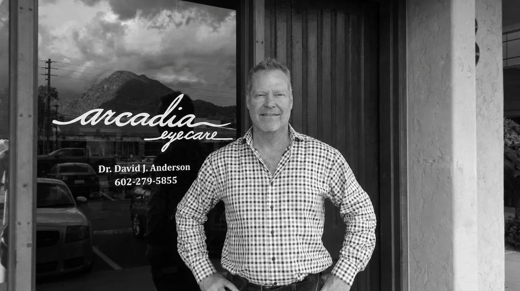 Man standing in front of Arcadia Eyecare.