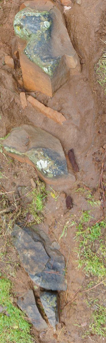Group of stones with unique characteristics and decorated + patterned. In close proximity to slabs.