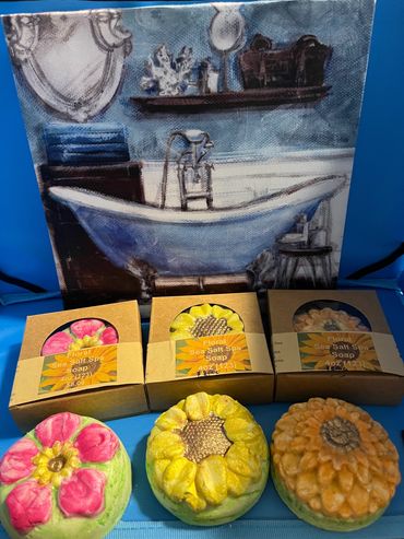 Floral sea salt spa soaps in flower shapes displayed with a bathtub painting.