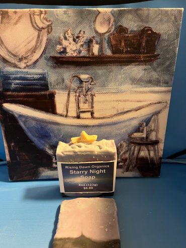 Artisan soap labeled Starry Night Soap with a bathtub painting backdrop.